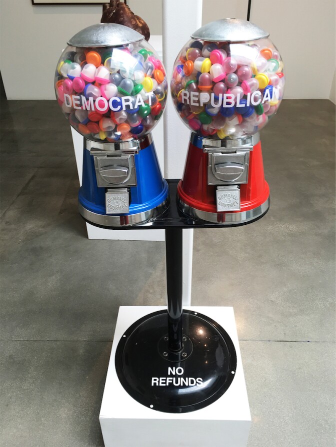Native American artist Gerald Clarke Jr. uses a gumball machine to explore the electoral process in his sculpture "Democracy for Sale."