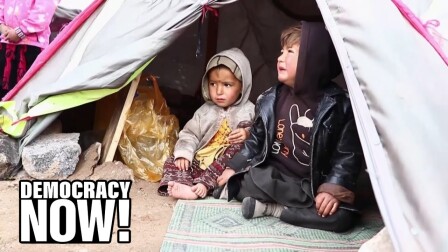 Afghan children sitting inside a tent.
