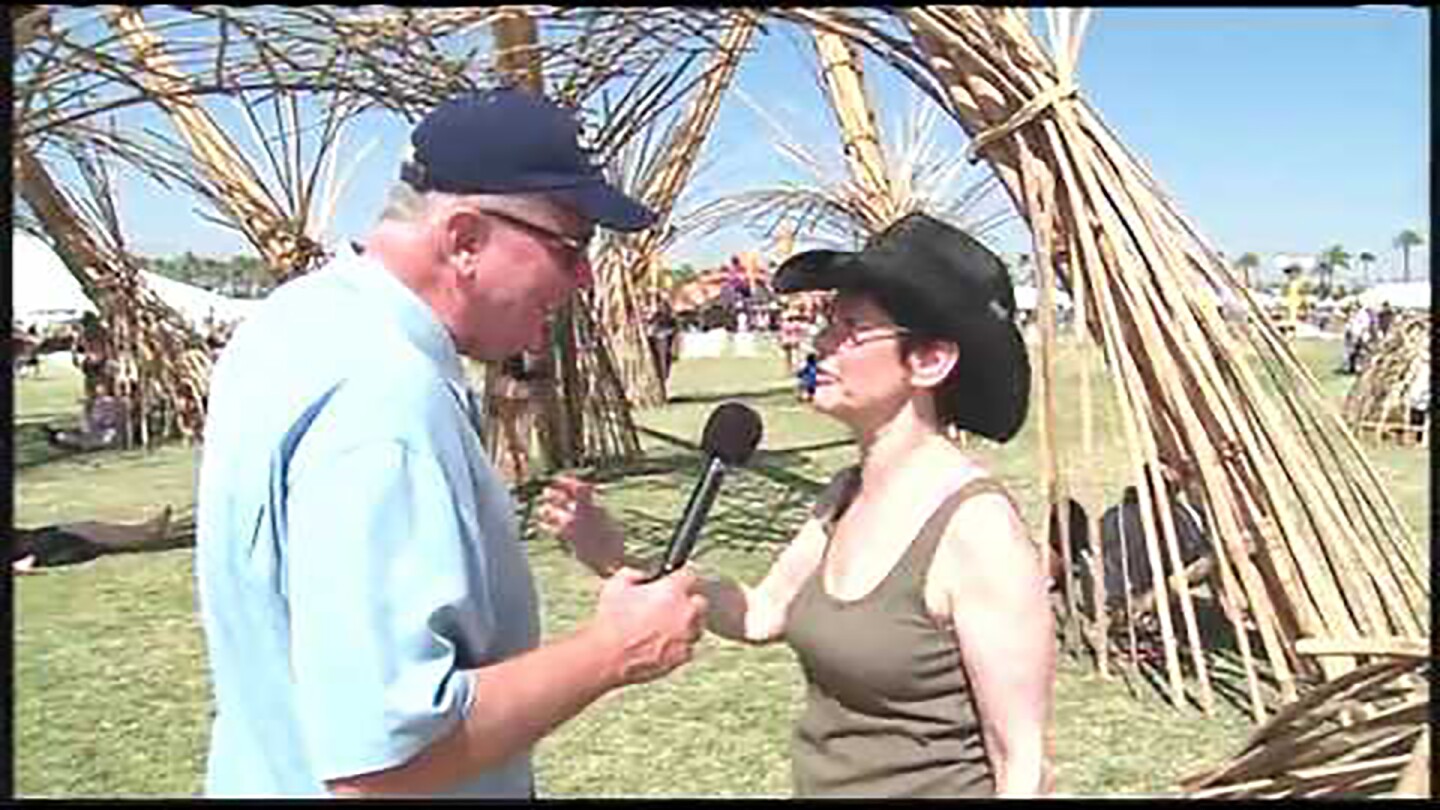 Huell Howser interviews someone at Coachella.