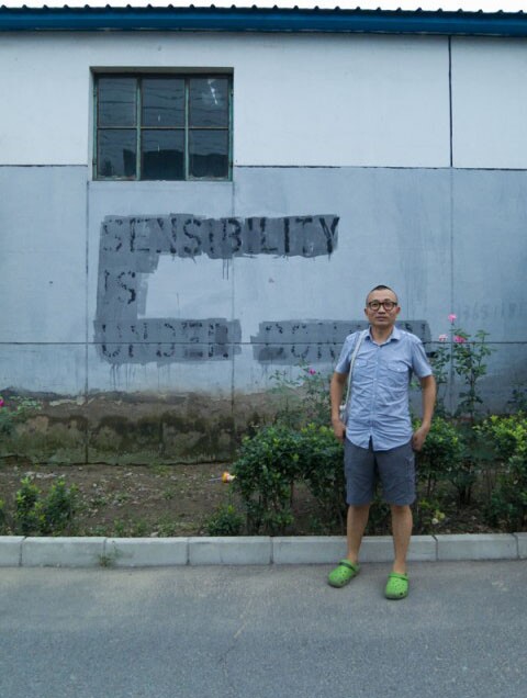 Ma Yongfeng with 'Sensibility is Under Control' painted over | Photo by Daniel Lara