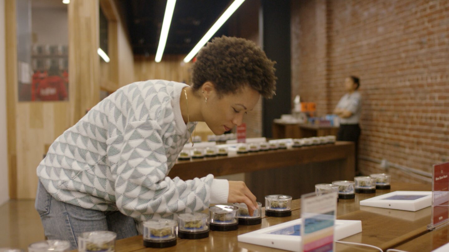 Customer at browses through cannabis samples at Med Men. | Still from "Broken Bread