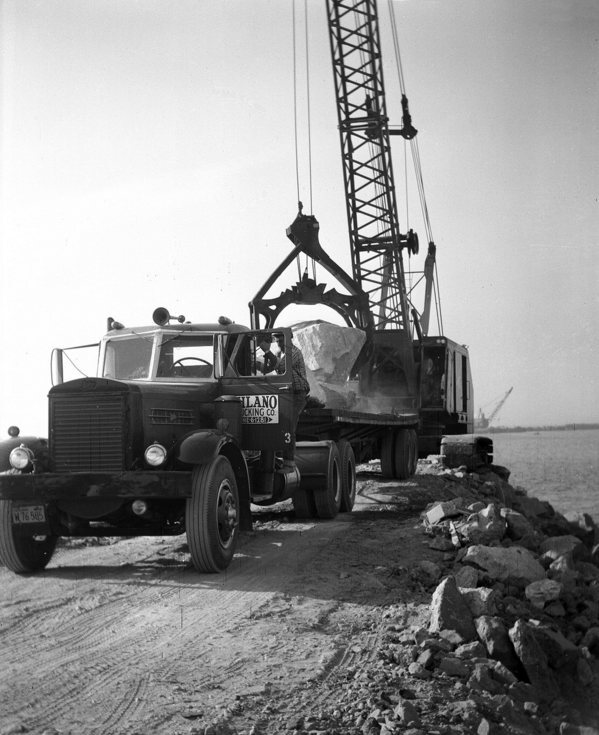 Trucks hauled in granite boulders from a quarry near San Marcos to create the harbor's breakwaters. Other rocks came by barge from Catalina island. Courtesy of the Orange County Archives.