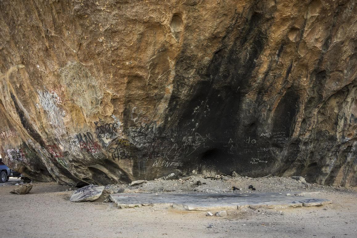 The north side of Giant Rock showing soot and ash of past bonfires staged here. A concrete slab covers the location of Critzer's former underground home | Kim Stringfellow
