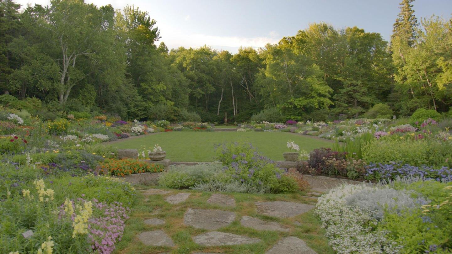 A garden landscape including a stone path and many different colored flowers. | "Beatrix Farrand's American Landscapes"