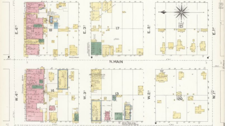 A blueprint of a city block with color-coded markings in the the squares. Residences housed by Chinese were marked in red on a fire insurance blueprint. 