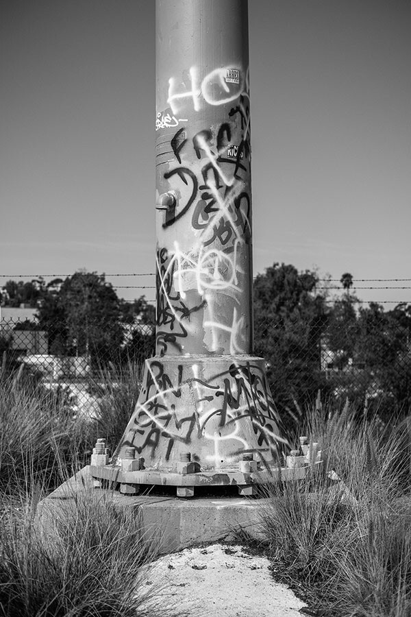 Street artists draw a distinction between the more elaborate and colorful graffiti art that is found on some of the larger structures around the Bowtie Parcel, and gang-affiliated “tags,” like those seen on this utility pole | Photo by Bear Guerra