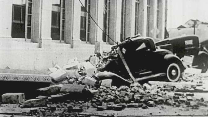 Car buried under bricks from collapsed building following the 1933 Long Beach Earthquake.