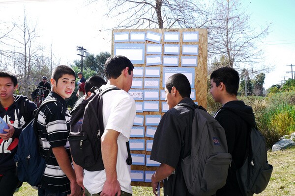 Local students gather around the kiosk