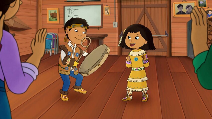 Cartoon of a little boy and girl in traditional clothing. The boy is playing a drum while the girl smiles.