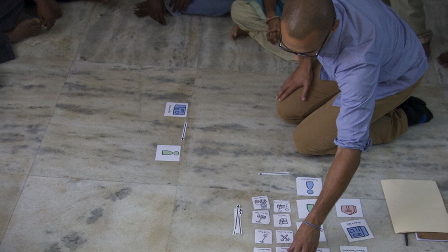 Rafael Smith, a designer at IDEO.org, mapping group decision-making processes with an organization in Southern India. | Danny Alexander, IDEO.org
