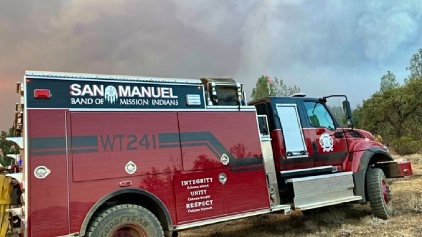 a fire truck with smoke in the background