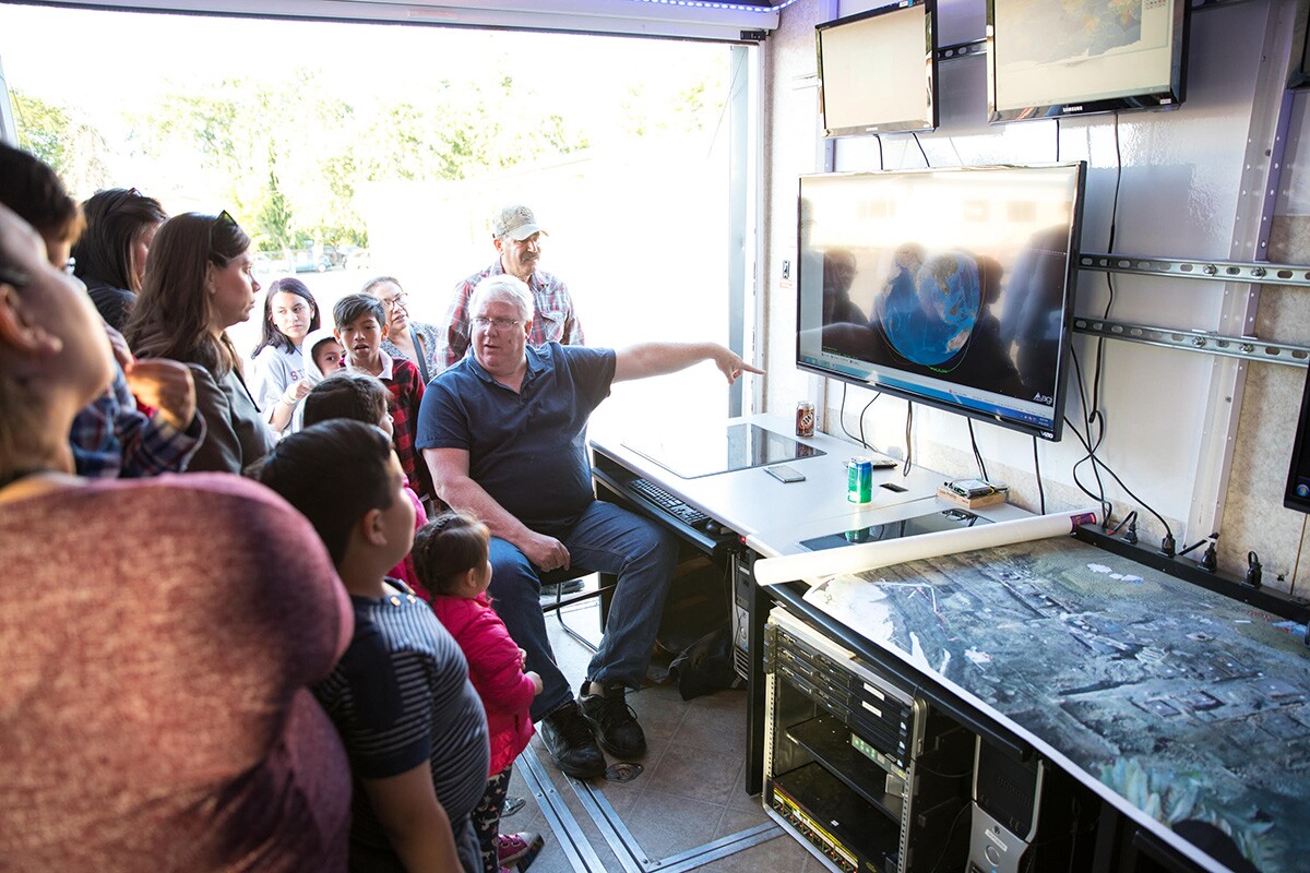 Christopher Kitts in the mobile mission control center during a recent outreach event. | Courtesy of R. Mike Rasay
