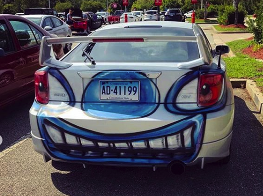 The back of a white sedan bombed by Kenny Scharf for his "Karbombz!" project | Courtesy of the artist