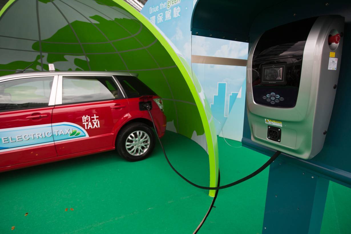 ARCHIVE PHOTO: A BYD E6 electric car is seen plugged into a charging unit during a launch ceremony for the line vehicles in Hong Kong, May 15, 2013. | REUTERS/Tyrone Siu