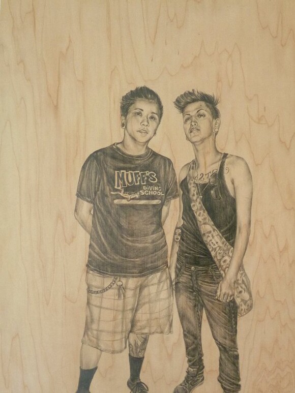 Two people, Cristina and Felix, are drawn on wood.