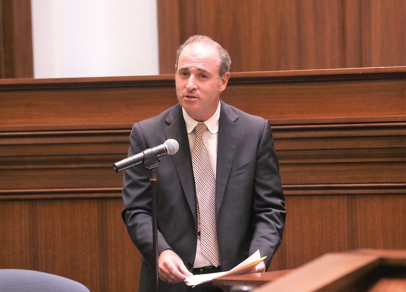 Joshua P. Groban stands behind a microphone in a courtroom