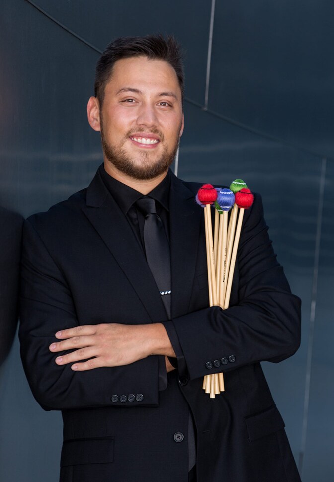 Howard Matthew holds his drumming implements. | Craig T. Mathew of Mathew Imaging