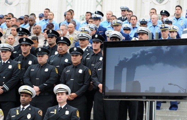 Members of the Los Angeles Fire Department and guests watch a video presentation recounting the events of 9/11 | Photo: ROBYN BECK/AFP/Getty Images