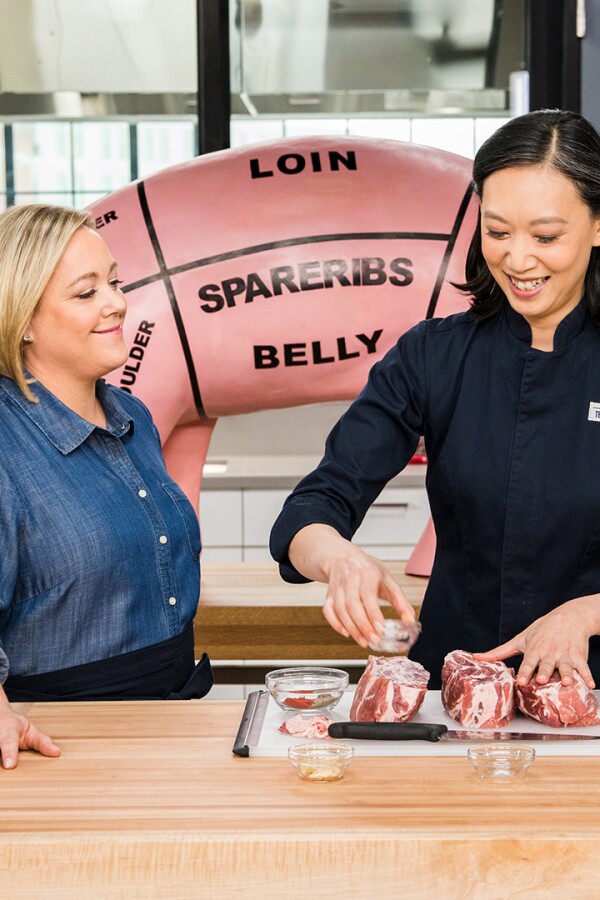 Julia Collin Davison and Lan Lam preparing pork in the test kitchen.
