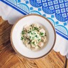 A bowl of Russian dumplings on a table.
