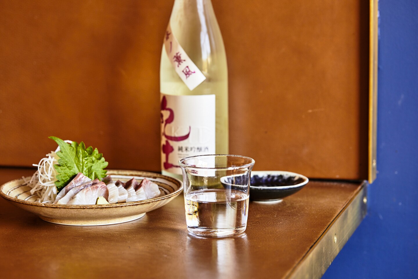 A cup of ginjo sake paired with Tsubaki's kanpachi sashimi.