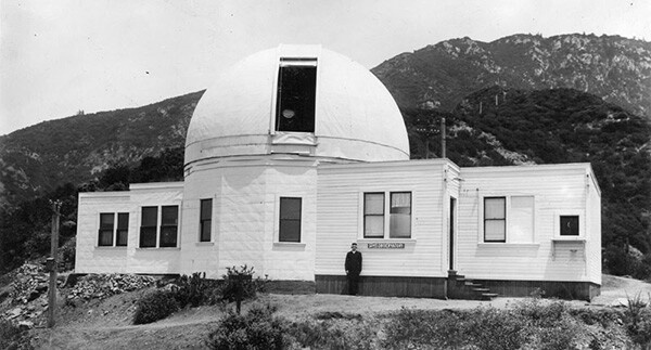 Observatory director Dr. Edward Larkin stands outside of the early wooden structure of the Mount Lowe Observatory at Echo Mountain in the San Gabriel Mountains. | Courtesy of the Los Angeles Public Library