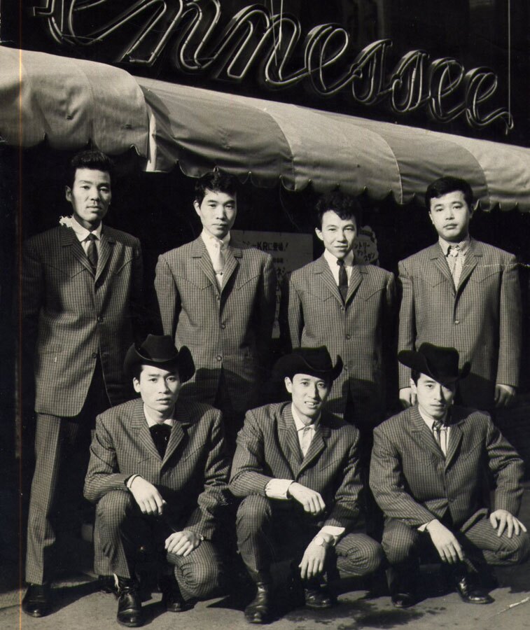 Jimmy Tokita & His Mountain Playboys (Front L-R: Akira Nagura, Jimmy Tokita, Giant Yoshida; Back L-R: Chosuke Ikariya, Mitsuo Fujii, Takeshi Terauchi, Hisaya Miyagi) in front of the Tennesse club in Ginza, Tokyo. | Courtesy of J.T. Kanehira