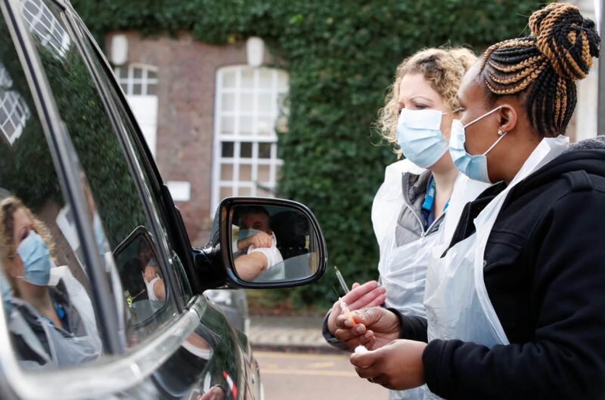 Health workers prepare to administer a COVID-19 vaccine at a drive-thru vaccination centre at Batchwood Hall, amid the outbreak of coronavirus disease (COVID-19) in St. Albans, Britain, February 5, 2021.