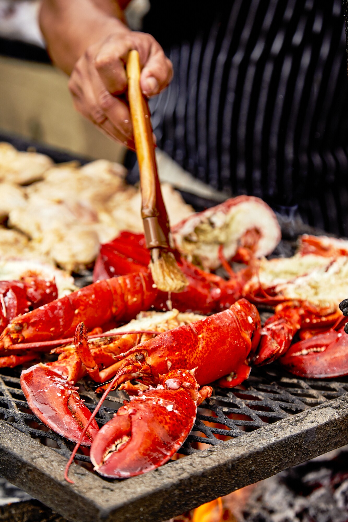 A close-up shot of Johnny Angeles of Lobsterdamus butters up lobster at the FilLed Market.