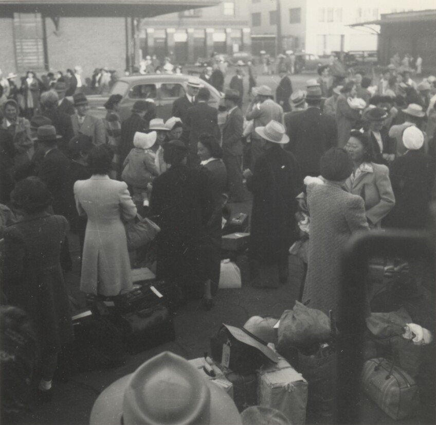 JANM- Japanese Americans wait at a Los Angeles, California, train station. They are bound for Parker, Arizona (Poston concentration camp), May 29, 1942.jpg