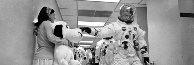 Thomas P. Stafford petting Snoopy as Jayme Flowers Coplin holds him. | NASA