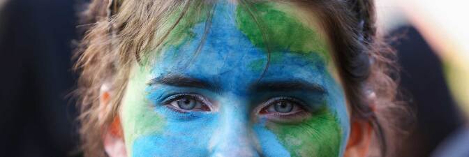 A protestor in New Zealand looks on during a strike to raise climate change awareness in September 2019. | Hagen Hopkins/Getty Images