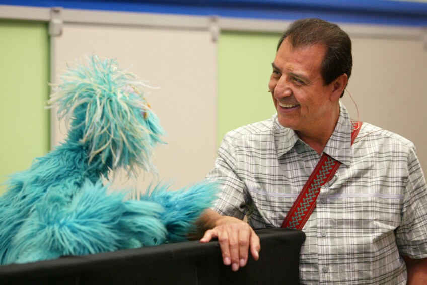 Sesame Street's Luis, played by Emilio Delgado, and Muppet Rosita chat on June 25, 2003 in New York City during the introduction of the "You Can Ask!" program, which aimed to help identify and deal with stress in children ages 3 to 8 in the aftermath of the September 11, 2001 terrorist attacks.