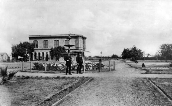 Another 1887 view of the plaza, showing two men who are often (but questionably) identified as Orange's founders, Alfred Chapman and Andrew Glassell. Courtesy of the USC Libraries - California Historical Society Collection.