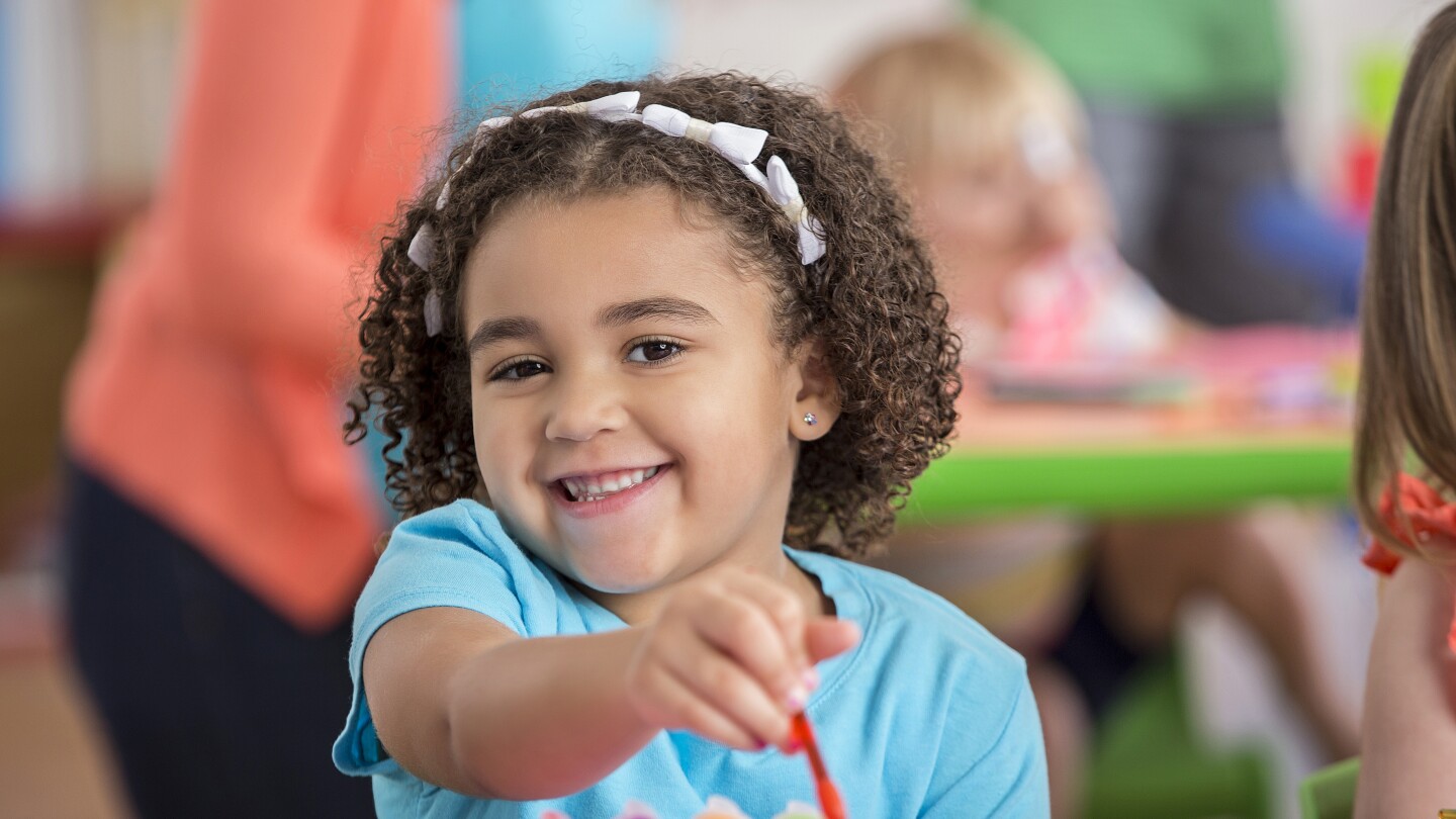 Adorable preschooler paints a picture