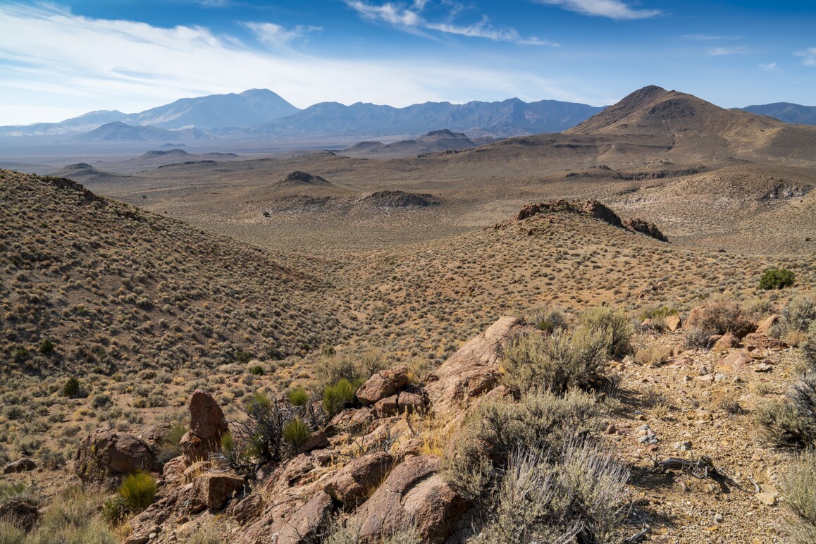 A desert landscape with visible hills beyond.