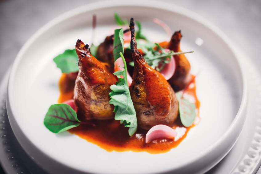 Beet Pibil with Yellow Beet, Achiote, Pickled Onion and Bitter Greens. A dish from Ray Garcia's Broken Spanish | Courtesy of Life & Thyme