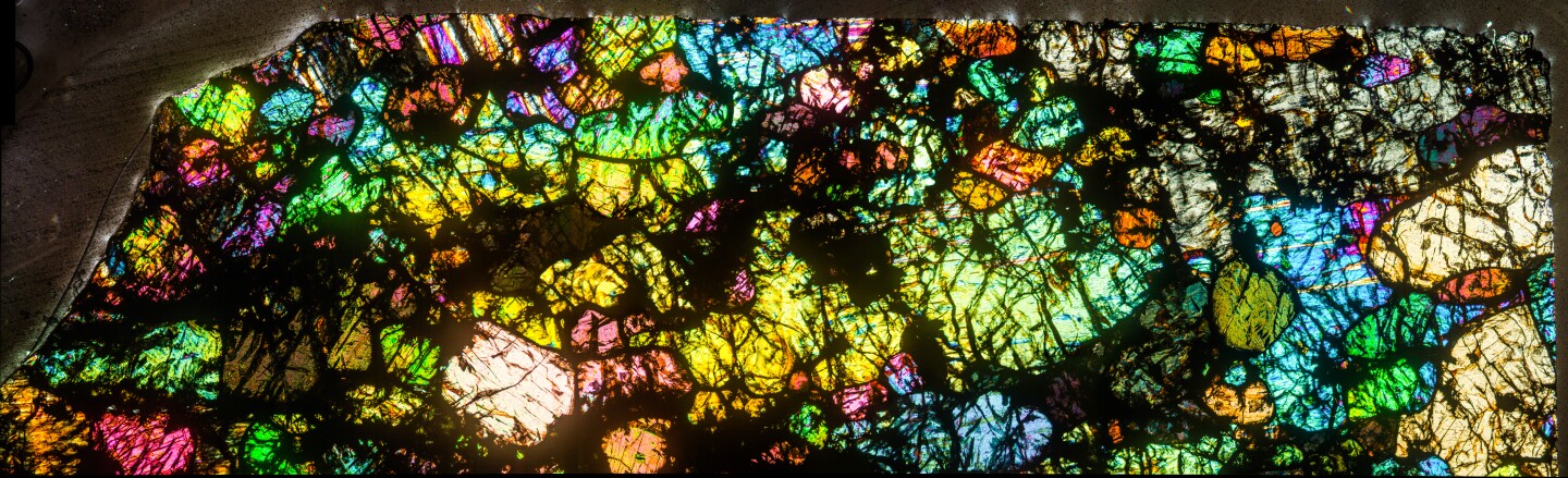 A thin, colorful section of a hot desert meteorite found in Africa.