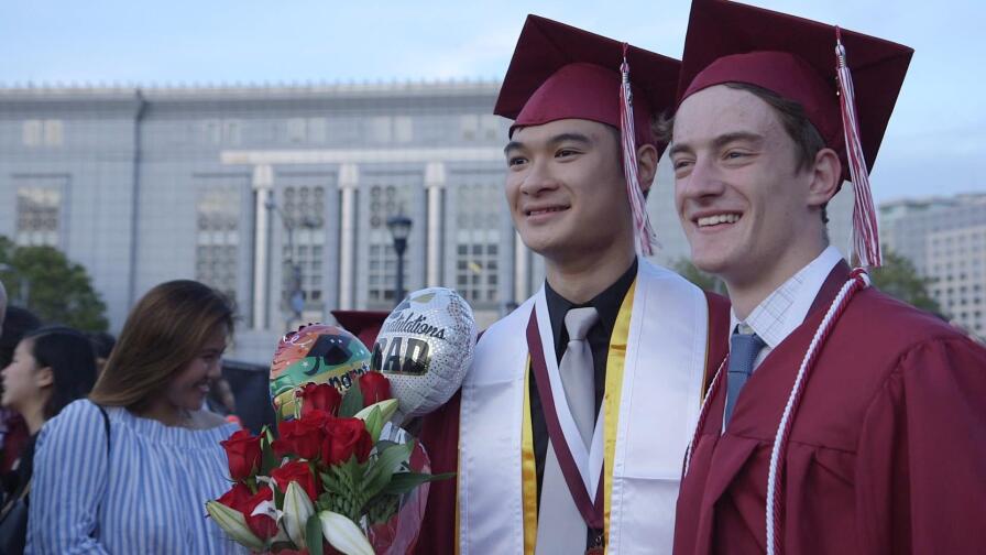 Two Lowell High School graduates standing side by side.