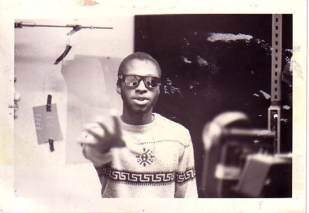 A black and white man in sweater and sunglasses.