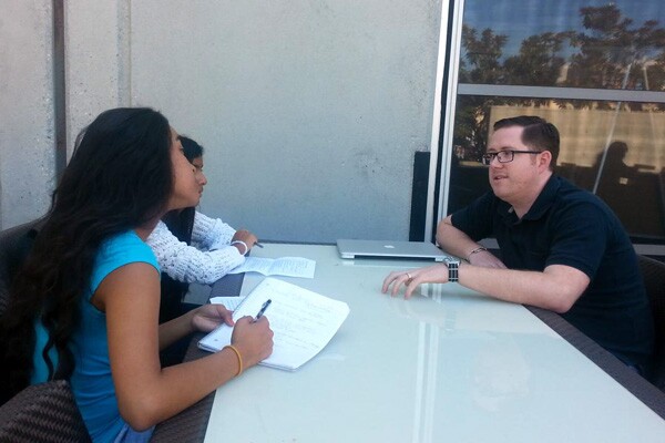 Two students interviewing Jeremy Bunting, Associate Technology Director at Deutsch