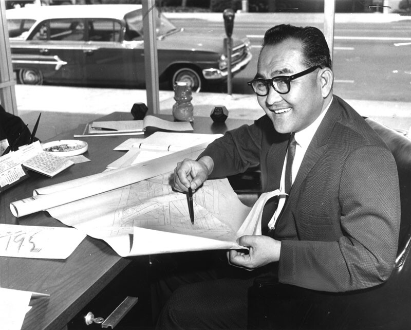 Bruce Kaji photographed in 1964 with a plan for Little Tokyo.