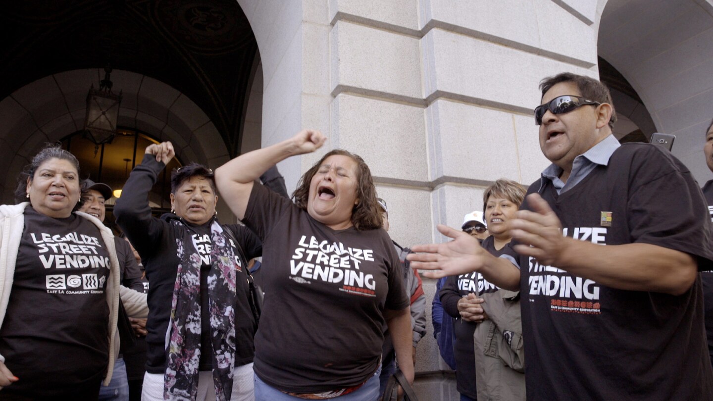Caridad and other street vendors protesting on the steps of City Hall