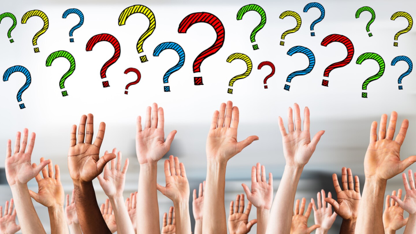 Hands raised in the air with question marks