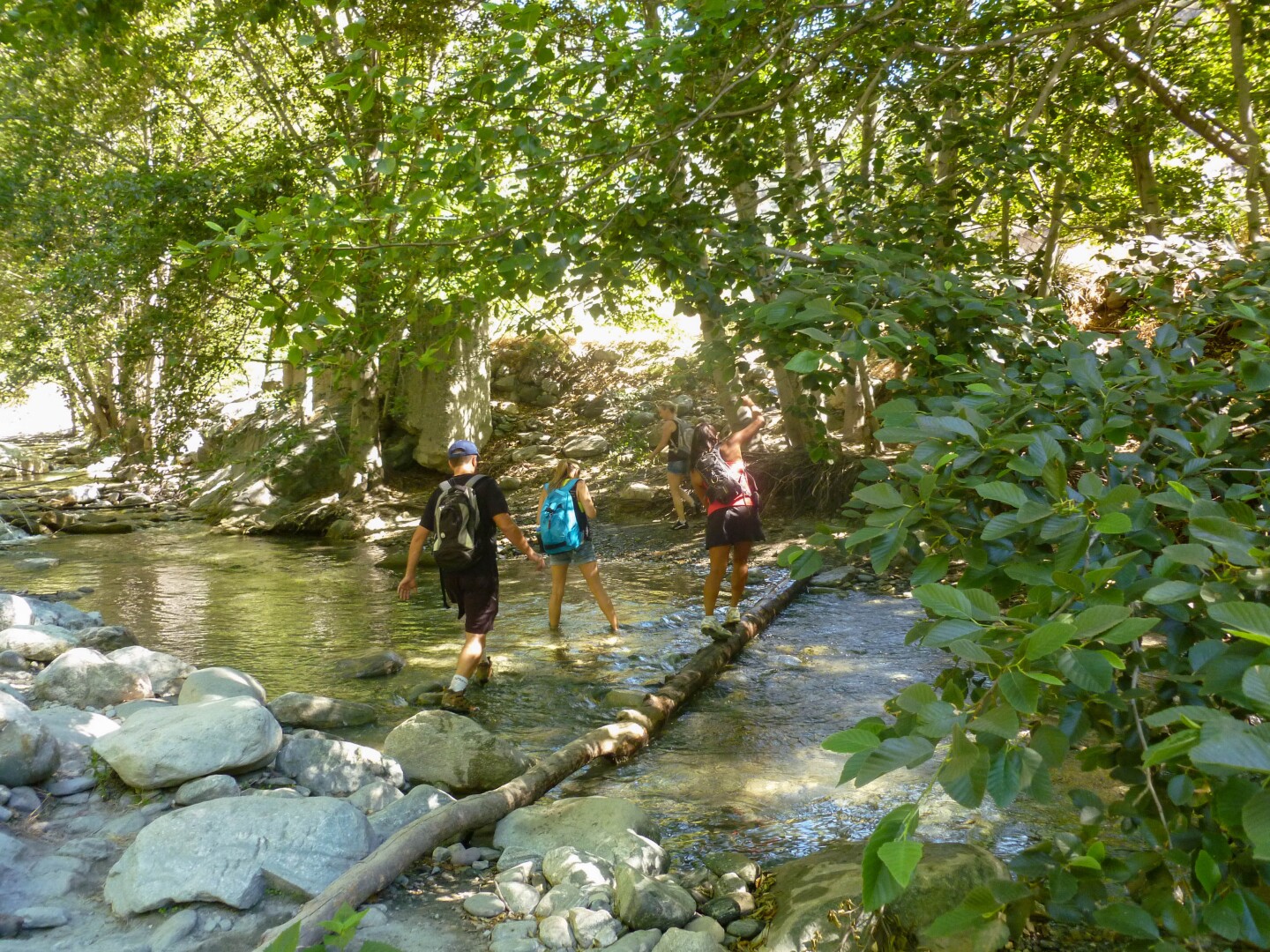 Hikers wade through the East Fork of the San Gabriel River.