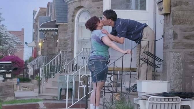 Dina and her partner Scott exchange a kiss on a doorstep. | From "Dina"