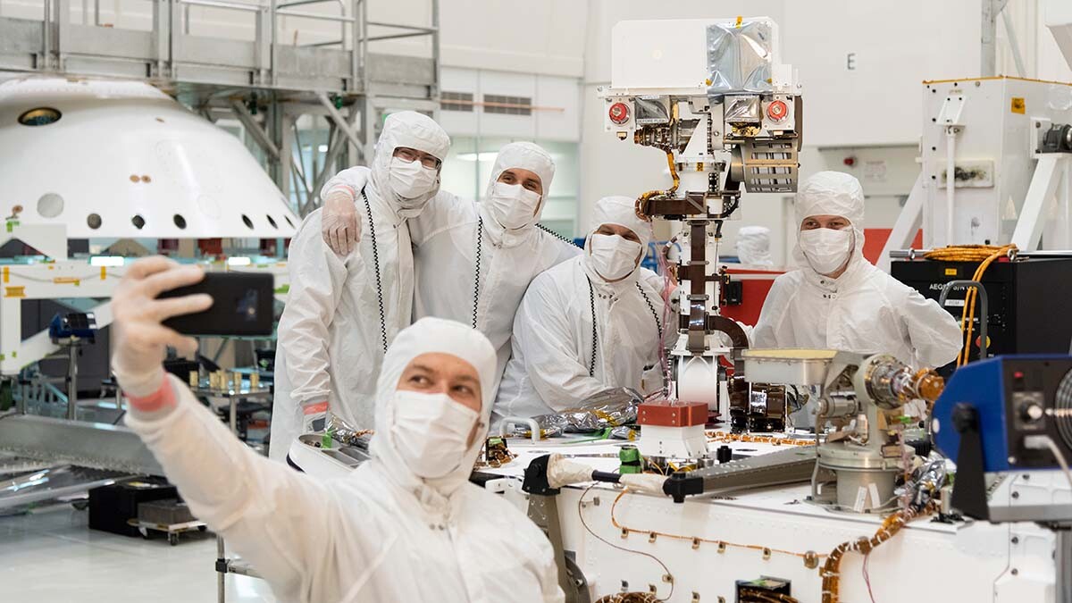 Members of NASA's Mars 2020 project take a moment after attaching the remote sensing mast to the Mars 2020 rover. | NASA/JPL-Caltech