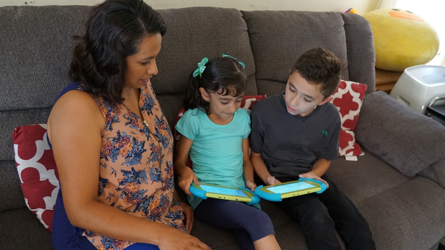 A mother and 2 young children using mobile devices. | PBS SoCal