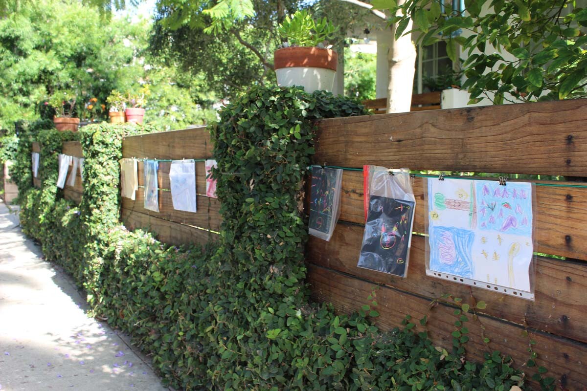 Detail of the children's artwork hanging from a cable on Dan Fields’ Los Feliz fence gallery. | Jean Trinh