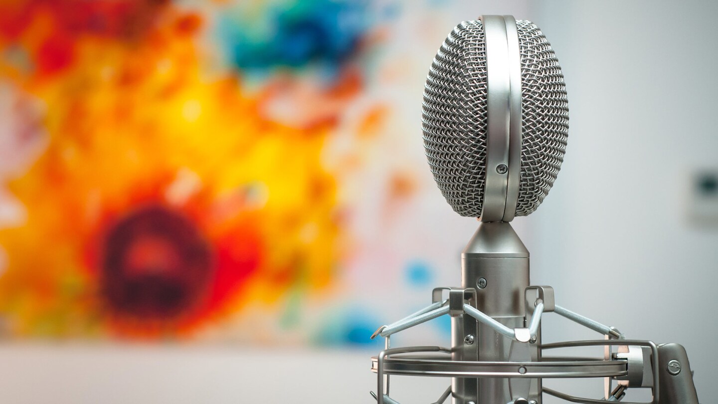 Gray microphone with a colorful art background | Michal Czyz / Unsplash
